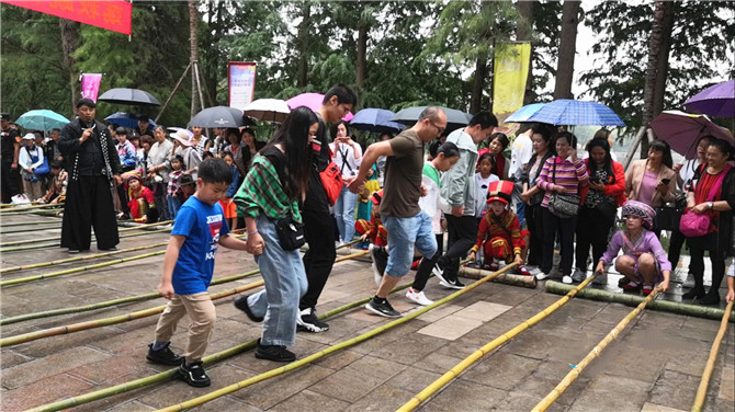 Tourists try bamboo pole dance